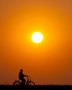 Senior man riding bicycle at sunset Royalty Free Stock Photo