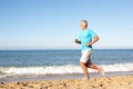 Senior Man Running Along Beach Royalty Free Stock Photo