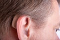 Senior man`s ear wearing hearing aid Royalty Free Stock Photo
