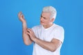 Senior man scratching forearm. Allergy symptom Royalty Free Stock Photo