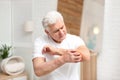 Senior man scratching forearm. Allergy symptom Royalty Free Stock Photo