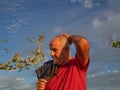 Senior man scratching his head thoughtfully listening to someone, jacket on his shoulder Royalty Free Stock Photo