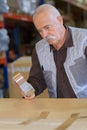 Senior man sealing cardboard box with tape dispenser Royalty Free Stock Photo