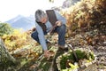 Senior man searching for ceps in forest