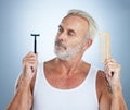 Senior man, shaver and comb thinking for grooming, skincare or hair removal against studio background. thoughtful mature Royalty Free Stock Photo