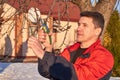 Senior man with shears in hand pruning tree branches in early spring