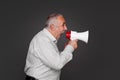 Senior man shouting using megaphone