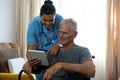 Senior man showing digital tablet to female doctor Royalty Free Stock Photo