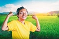 Senior Man showing off muscle for strong healthy lifestye concept in a nature farming field background