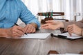 Senior man signing document with lawyer Royalty Free Stock Photo