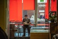 Senior man sits in a small cafe and drinks beer Royalty Free Stock Photo