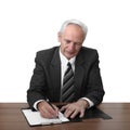 Senior man sits at table and writes document Royalty Free Stock Photo