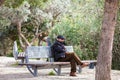 Senior man sitting alone on a bench