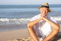 Senior man sitting on beach relaxing Royalty Free Stock Photo