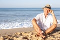 Senior man sitting on beach relaxing Royalty Free Stock Photo