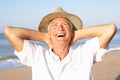 Senior man sitting on beach relaxing Royalty Free Stock Photo