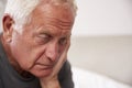 Senior Man Sitting On Bed At Home Suffering From Depression Royalty Free Stock Photo