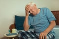 Senior Man Sitting On Bed Suffering From Depression Royalty Free Stock Photo