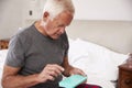 Senior Man Sitting On Bed At Home Taking Medication Royalty Free Stock Photo