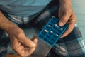 Senior man at home taking medication, close up Royalty Free Stock Photo