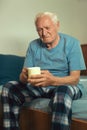 Senior Man Sitting On Bed Suffering From Depression Royalty Free Stock Photo