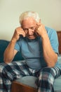 Senior Man Sitting On Bed Suffering From Depression Royalty Free Stock Photo