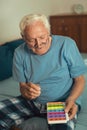 Senior Man Sitting On Bed Taking Medication Royalty Free Stock Photo