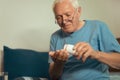 Senior Man Sitting On Bed Taking Medication Royalty Free Stock Photo