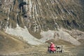 Senior man is sitting on the bench in the mountain Royalty Free Stock Photo