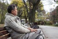 Senior man sitting on bench in the park Royalty Free Stock Photo