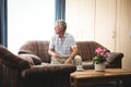 Senior man sitting on a couch Royalty Free Stock Photo