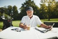 Senior man sitting at a course restaurant after playing golf Royalty Free Stock Photo