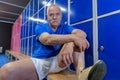 Senior man sitting in gym lockerroom Royalty Free Stock Photo