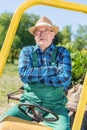 Senior man sitting proud in his tractor after cultivating his farm Royalty Free Stock Photo