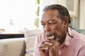 Senior Man Sitting On Sofa At Home Suffering From Depression Royalty Free Stock Photo