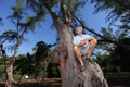 Senior man sitting on a tree