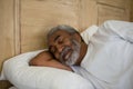 Senior man sleeping on bed in the bedroom Royalty Free Stock Photo