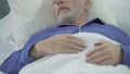 Senior man sleeping in bed and snoring loudly, problems with sleep, apnea