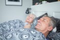 Senior man sleeping in comfortable bed with wife Royalty Free Stock Photo