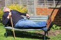 Senior man sleeping on park bench.