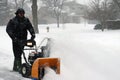 Senior man using snow blower during storm Royalty Free Stock Photo