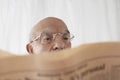 Senior man in spectacles reading newspaper close up Royalty Free Stock Photo