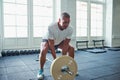 Senior man straing to lift weights in a gym