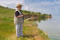 Senior man standing on abrupt riverside of the Dnepr river, Ukraine