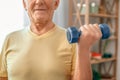 Senior man exercise at home health care with dumbbell in one hand close-up