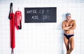 Senior man standing in an indoor swimming pool. Royalty Free Stock Photo