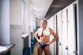 Senior man standing by the lockers in an indoor swimming pool. Royalty Free Stock Photo