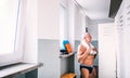 Senior man standing by the lockers in an indoor swimming pool. Royalty Free Stock Photo