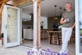 Senior Man Standing And Looking Out Of Kitchen Door Drinking Coffee Royalty Free Stock Photo