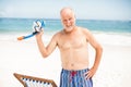 Senior man standing next to sunchair Royalty Free Stock Photo